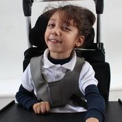 Child smiling in new wheelchair