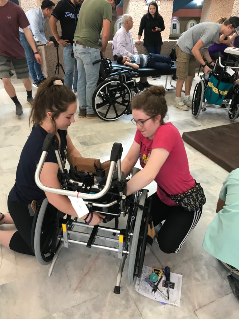 two volunteers assembling a wheelchair
