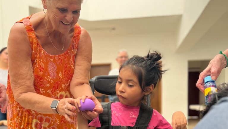 Girl receiving her new wheelchair