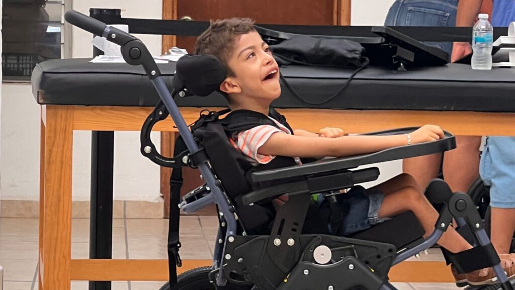 Boy in new wheelchair at the Mexico distribution