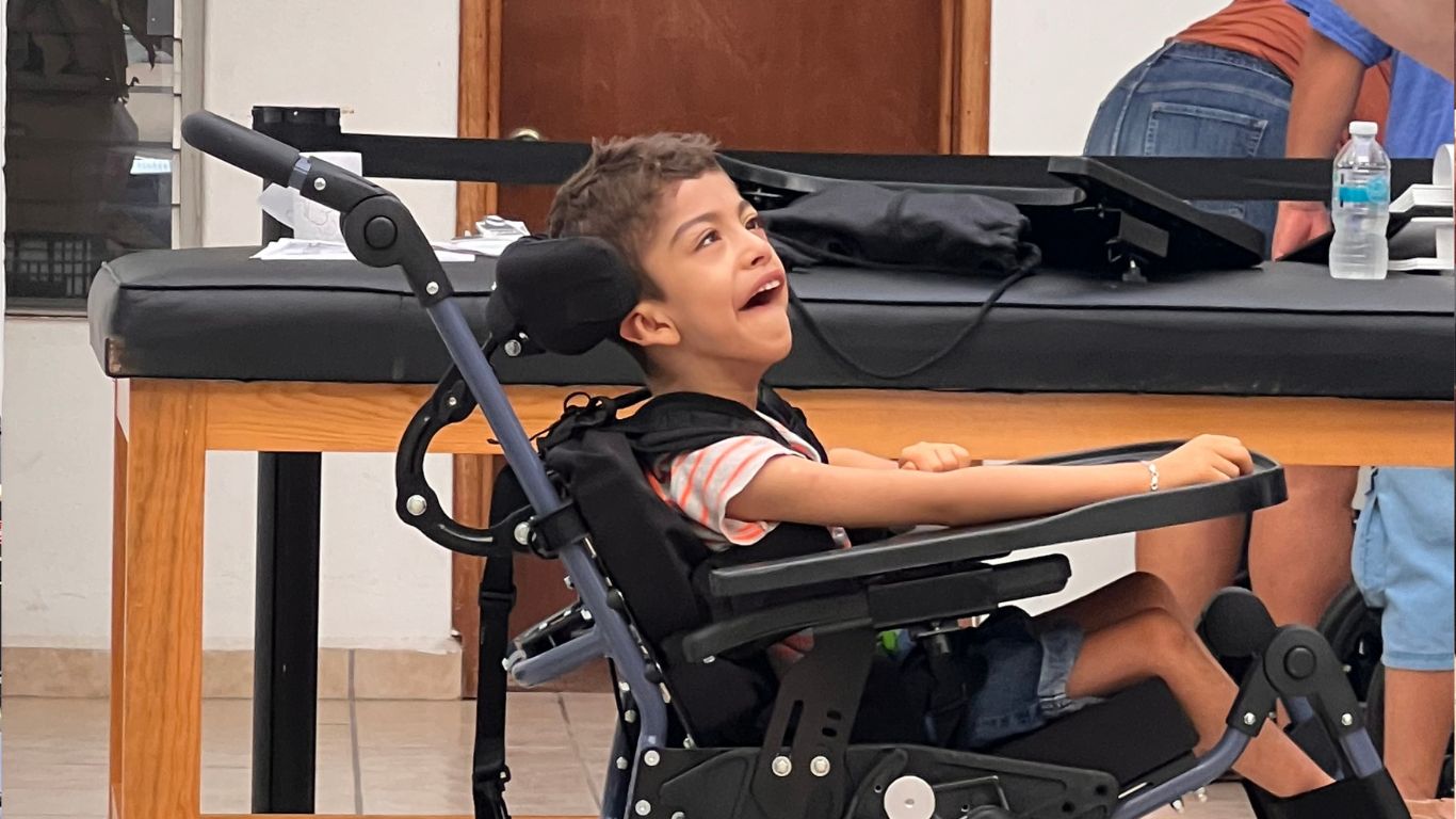 Boy in new wheelchair at the Mexico distribution