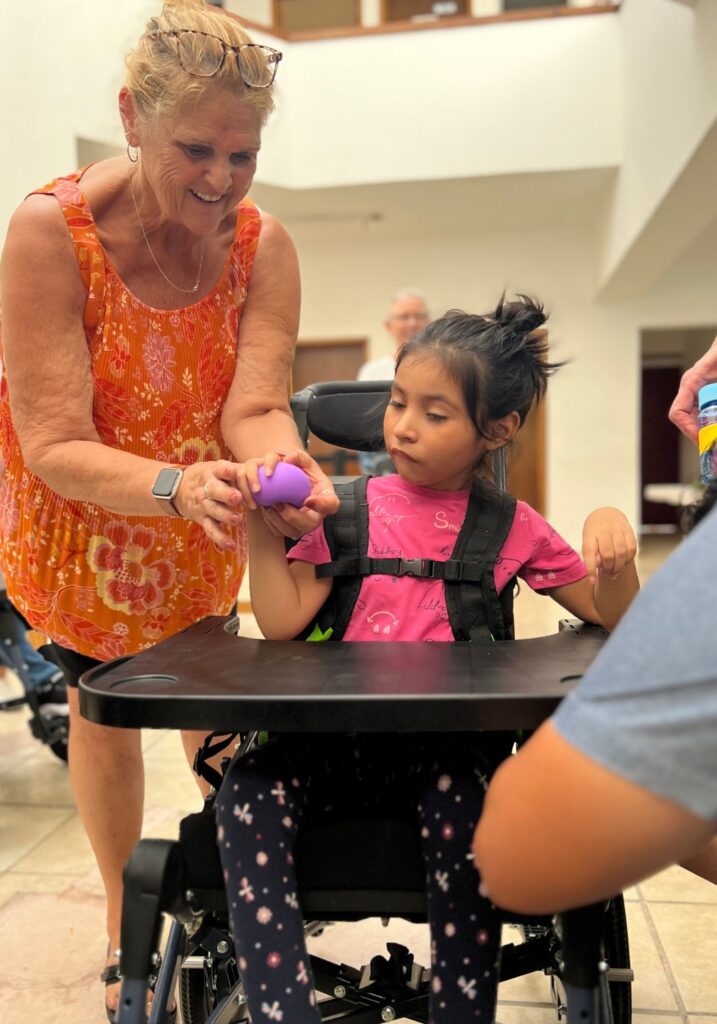 fitting a young girl for a wheelchair