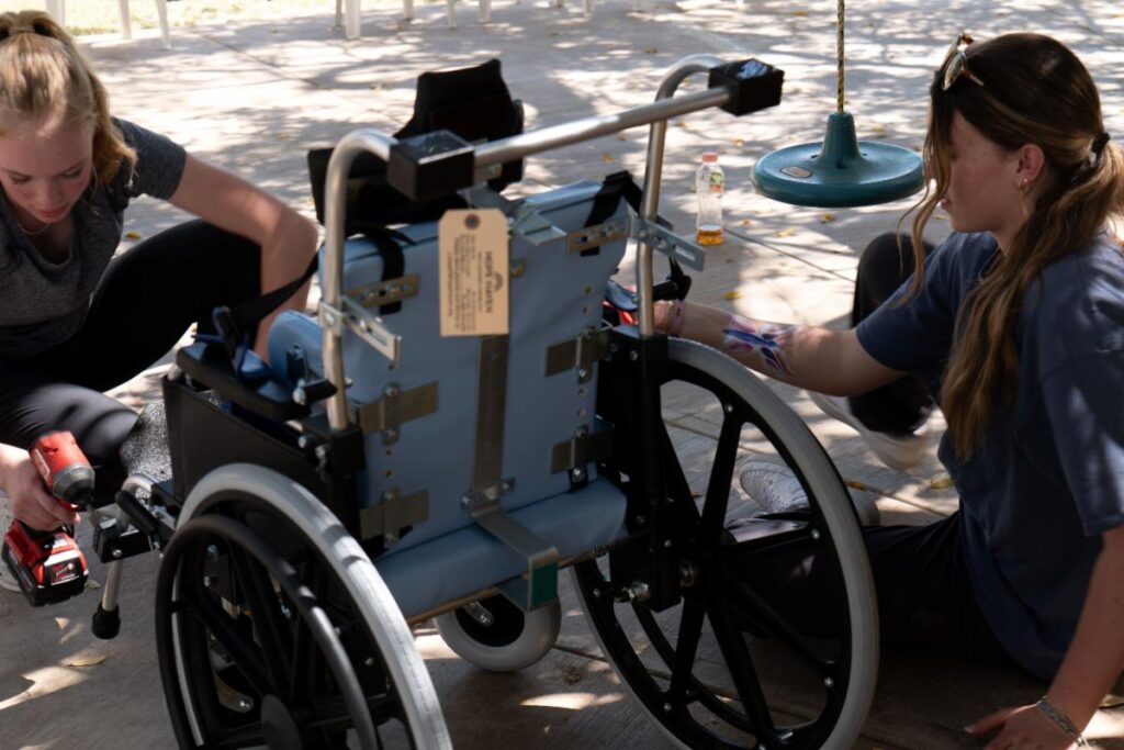 Teens assembling a wheelchair