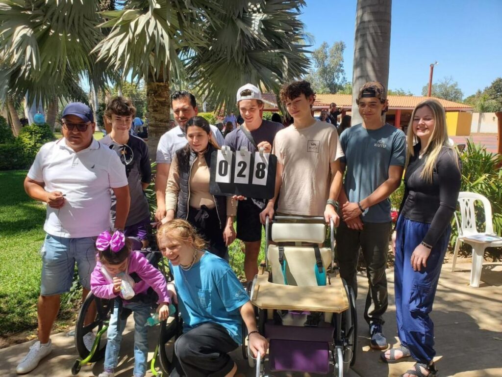 Youth ROC team with wheelchair recipient